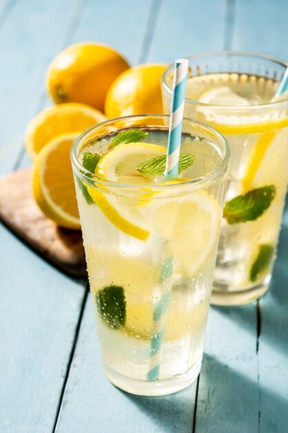 Glass of fresh lemonade on blue wooden table