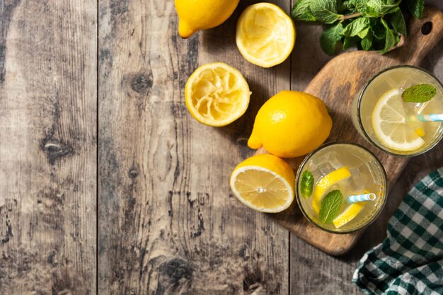 Glass of fresh lemonade on wooden table