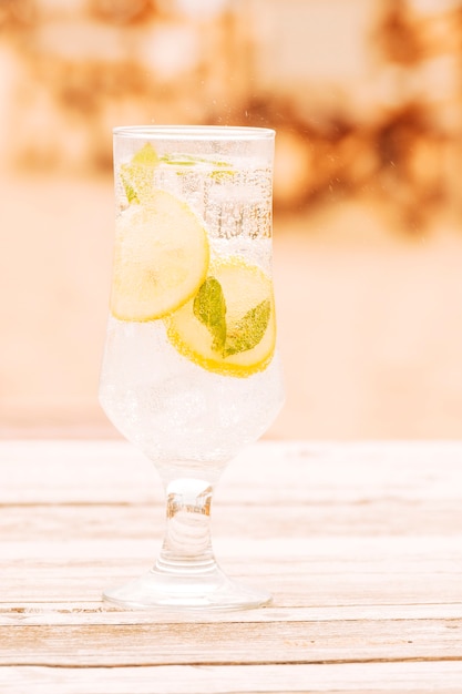 Glass of fresh mint drink on wooden surface