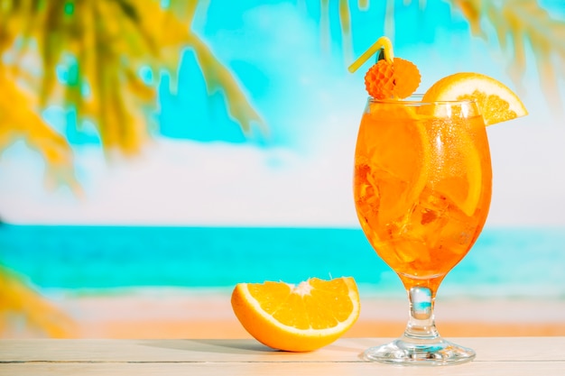 Glass of fresh orange drink and sliced orange