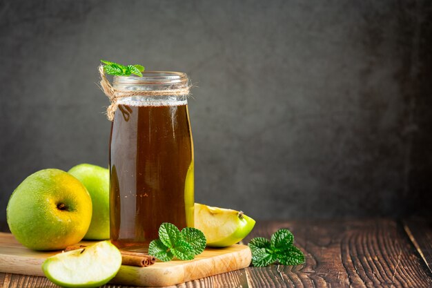 Glass of green apple healthy tea put next to fresh green apples