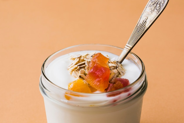 Glass jar of fresh oats, fruits and yogurt