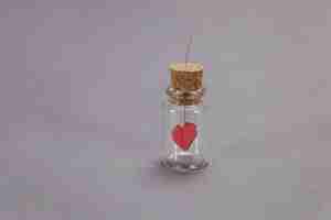 Free photo glass jar with a heart hanging inside