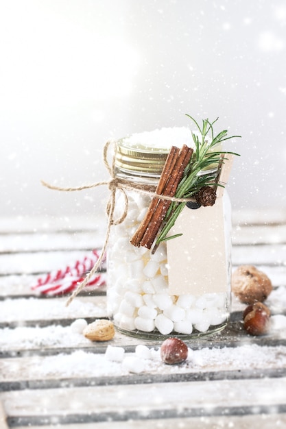 Glass jar with marshmallows and cinnamon tied with a rope