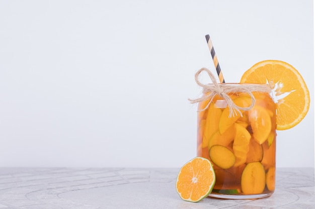 A glass of juice with fruit slices.