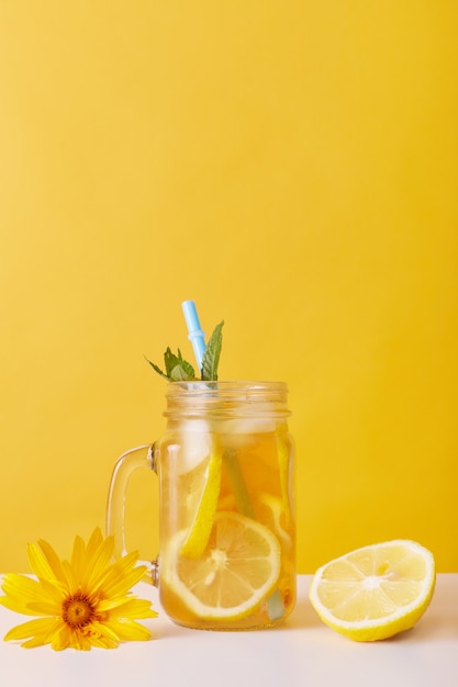 Glass of lemonade with lemon and mint