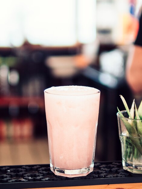 Glass of light pink beverage
