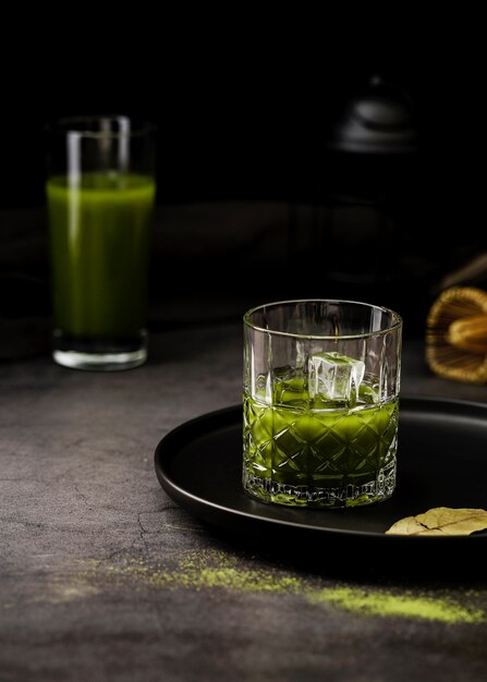 Glass of matcha tea with ice cubes