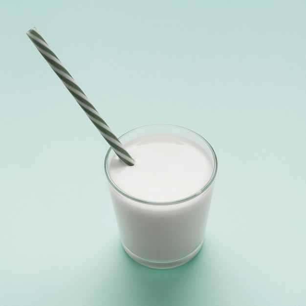 Glass of milk on blue background