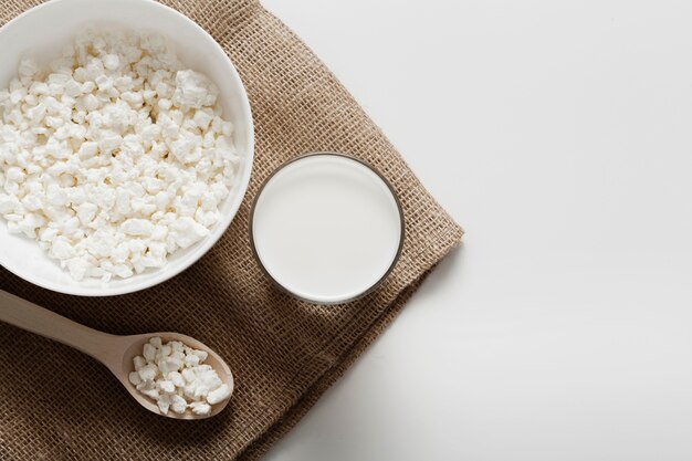 Glass of milk next to bowl of cereal