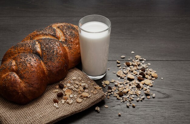 Foto gratuita bicchiere di latte accanto a pane fresco