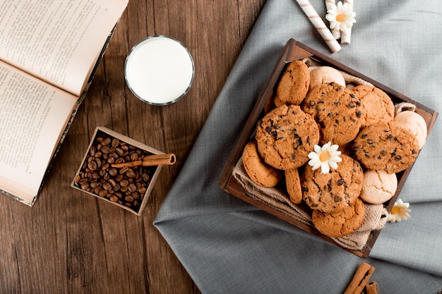 A glass of milk with biscuits.  