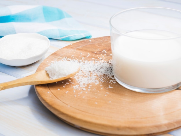 Glass of milk with grated coconut