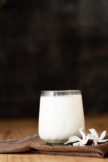 glass of milk on wood