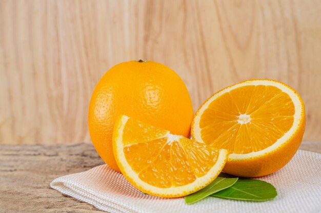 Glass of orange juice placed on wood.