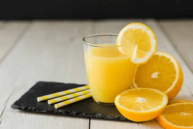 Glass of orange juice with straws