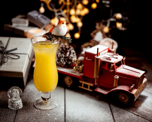 Free photo glass of orange juice with toy truck
