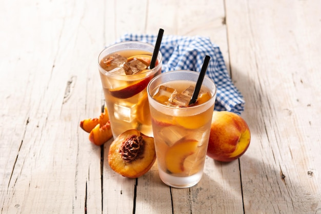 Free photo glass of peach tea with ice cubes