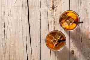 Free photo glass of peach tea with ice cubes