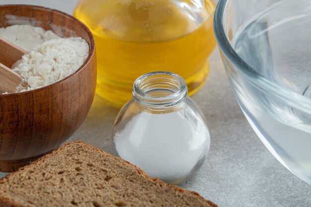 A glass plate of water with slices of bread and oil.