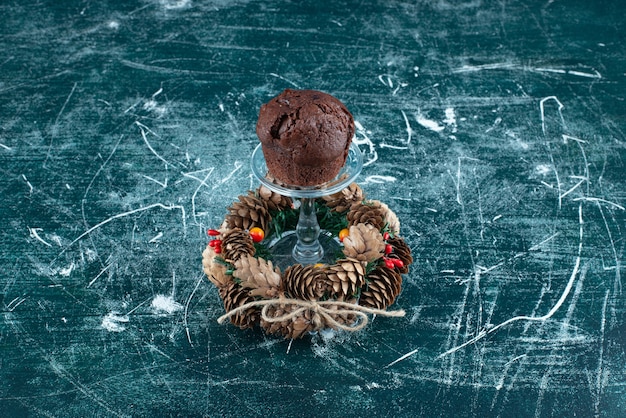 A glass plate with chocolate cookie and Christmas wreath. High quality photo