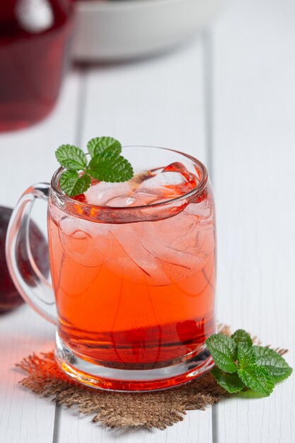 glass of plum put on white wooden floor