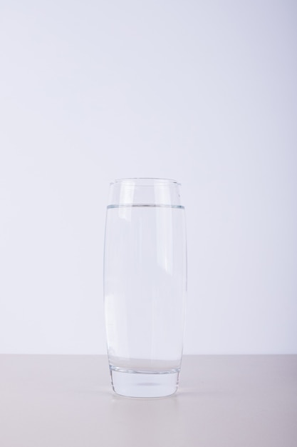 Glass of pure water on white.