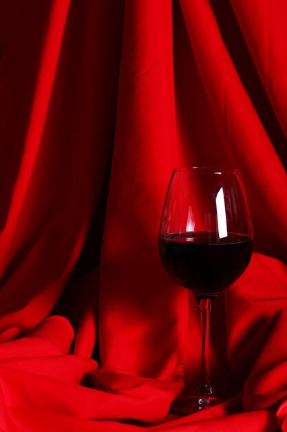 Glass of red wine on red cloth