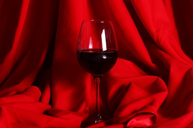 Glass of red wine on red cloth
