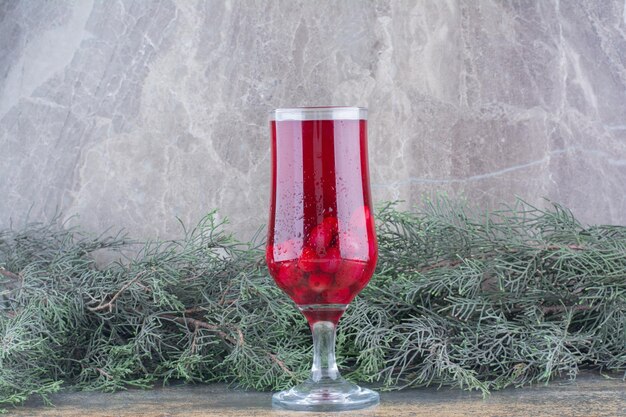 A glass of rosehips juice on marble background. High quality photo