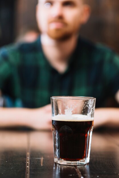 Glass of rum on wooden desk