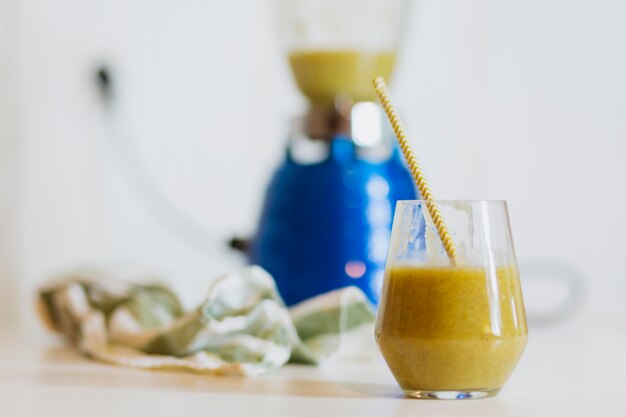 Glass of tasty green smoothie on table