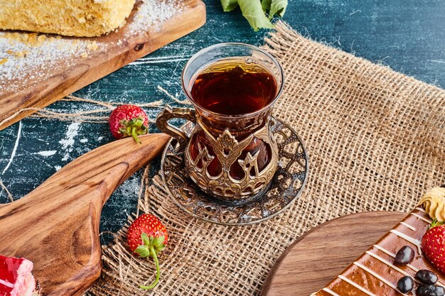 A glass of tea on a piece of burlap. 