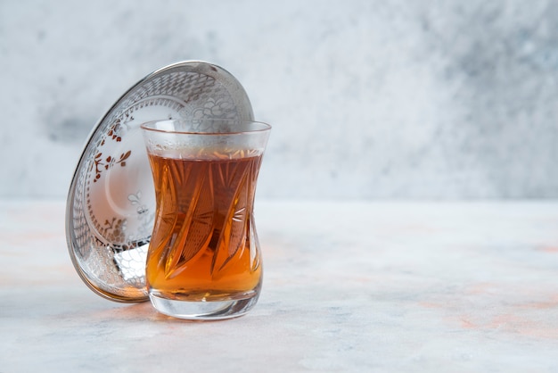 Free photo glass of tea on white surface