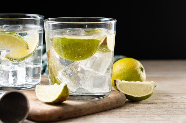 glass of vodka tonic cocktail on wooden table