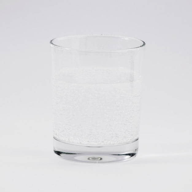 Glass of water on grey backdrop