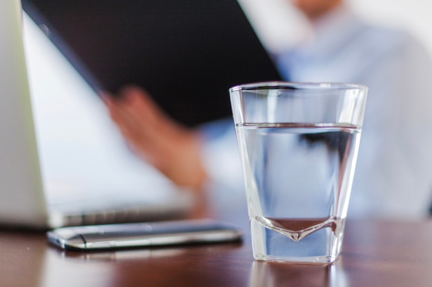 Glass of water standing on table