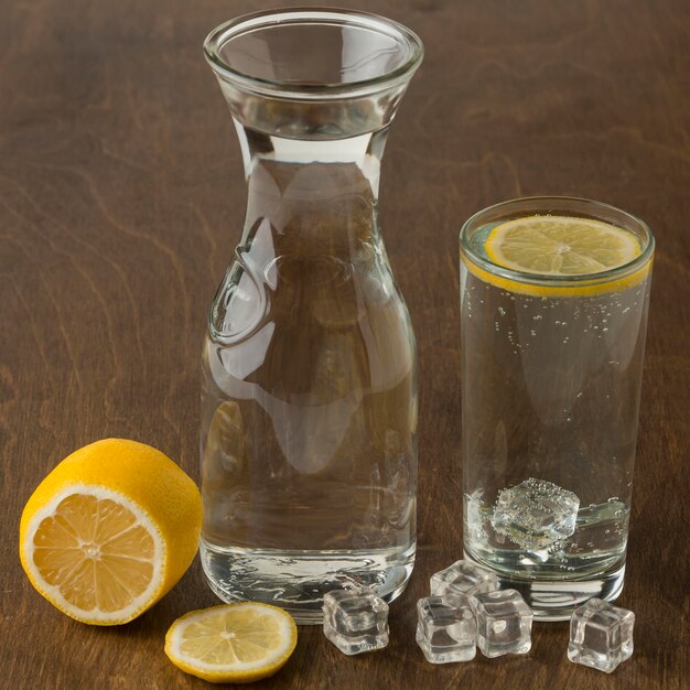 Glass of water with healthy lemon slice high view