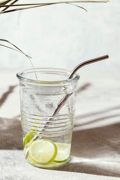 Glass of water with lemon slices on table