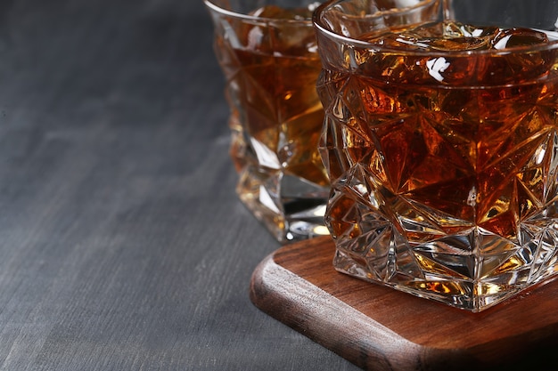 Free photo glass of whiskey or bourbon, only with ice