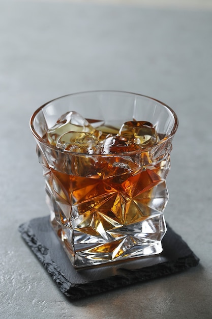 Free photo glass of whiskey or bourbon, only with ice