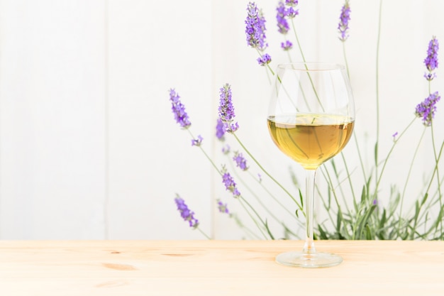 Glass of wine with lavender bush.