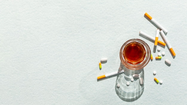 Glass with alcohol and cigarettes