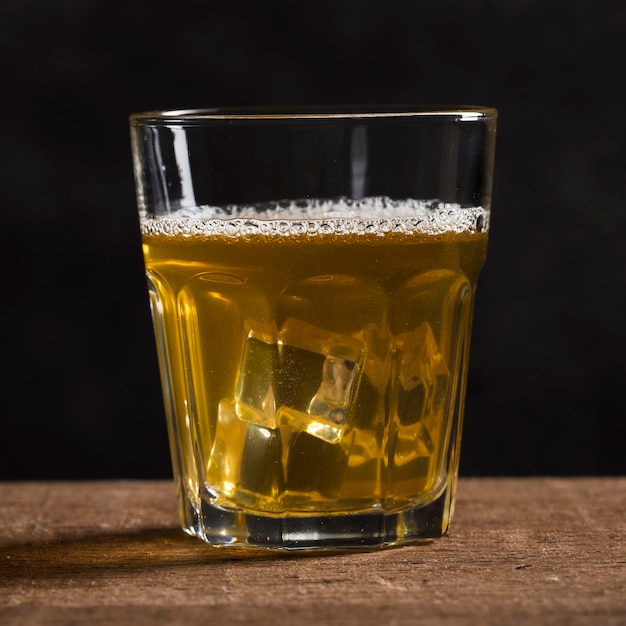 Glass with beer and ice cubes