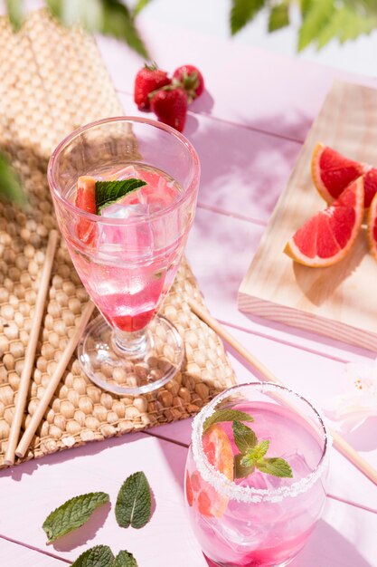 Glass with fresh fruits drinks on table