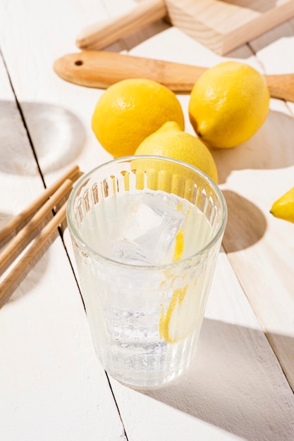 Glass with fresh lemonade on table