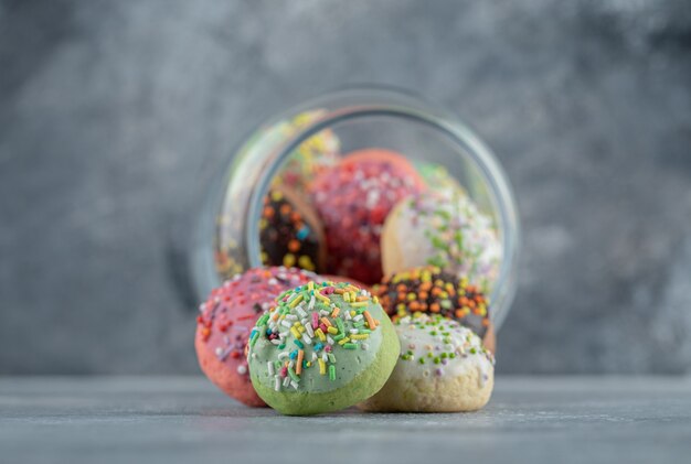 Free photo glass with full of cookies on marble table.