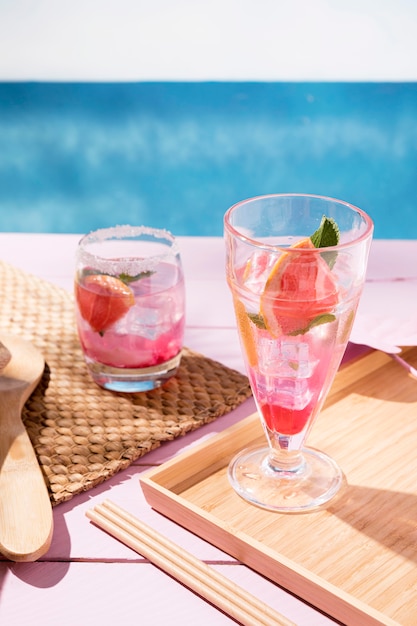 Glass with grapefruit drink in tray