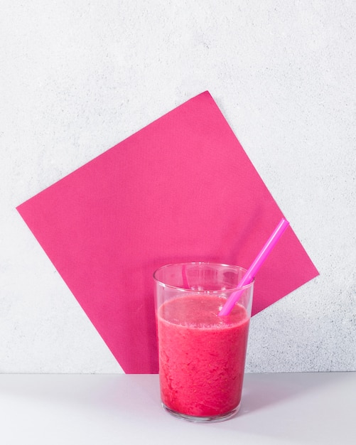 Glass with grapefruit smoothie on table