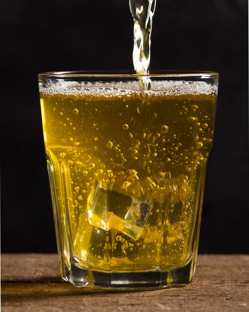 Glass with ice cubes and beer